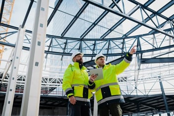 Construction managers using digital tablet on site