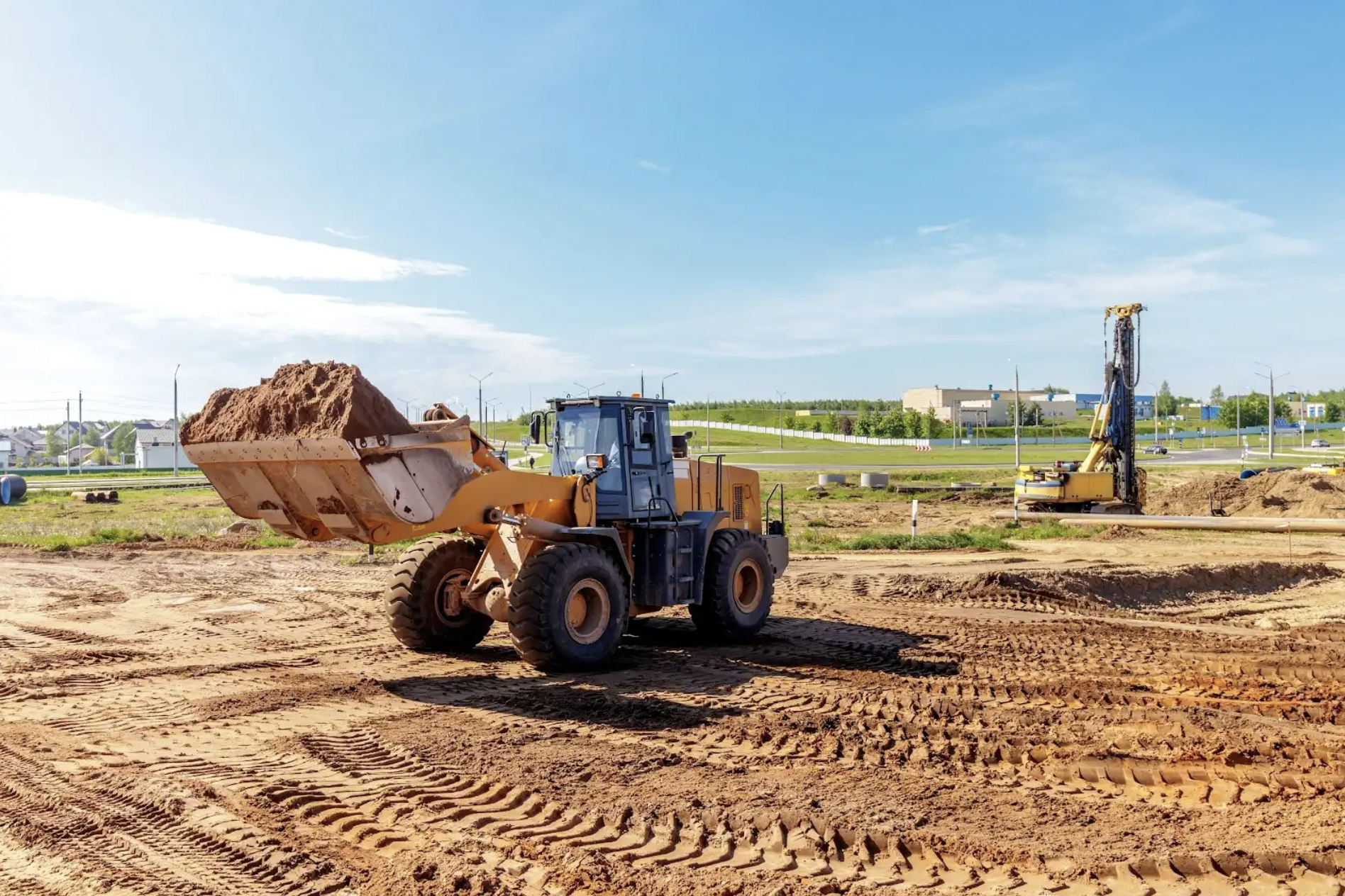 Construction equipment operating on a dirt field