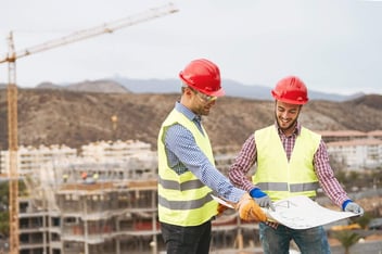 Work engineers discussing about new building area