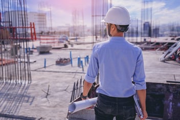 Smart civil architect engineer inspecting and working outdoors building side