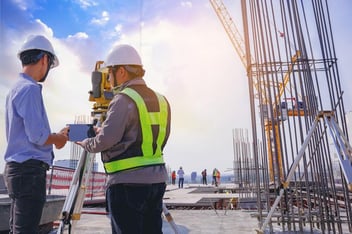 Engineer and surveyor worker working with theodolite transit equipment at outdoors 