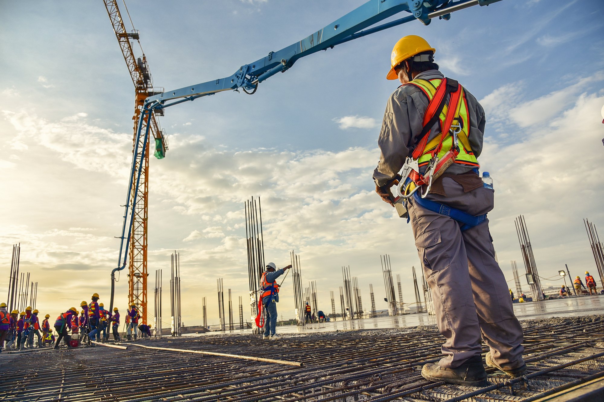 A construction worker control a pouring concrete pump on construction site